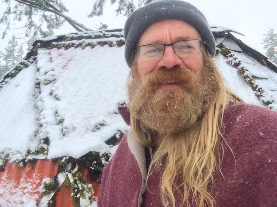 Tom standing in front of his finished geodesic dome in the snow, Alaska